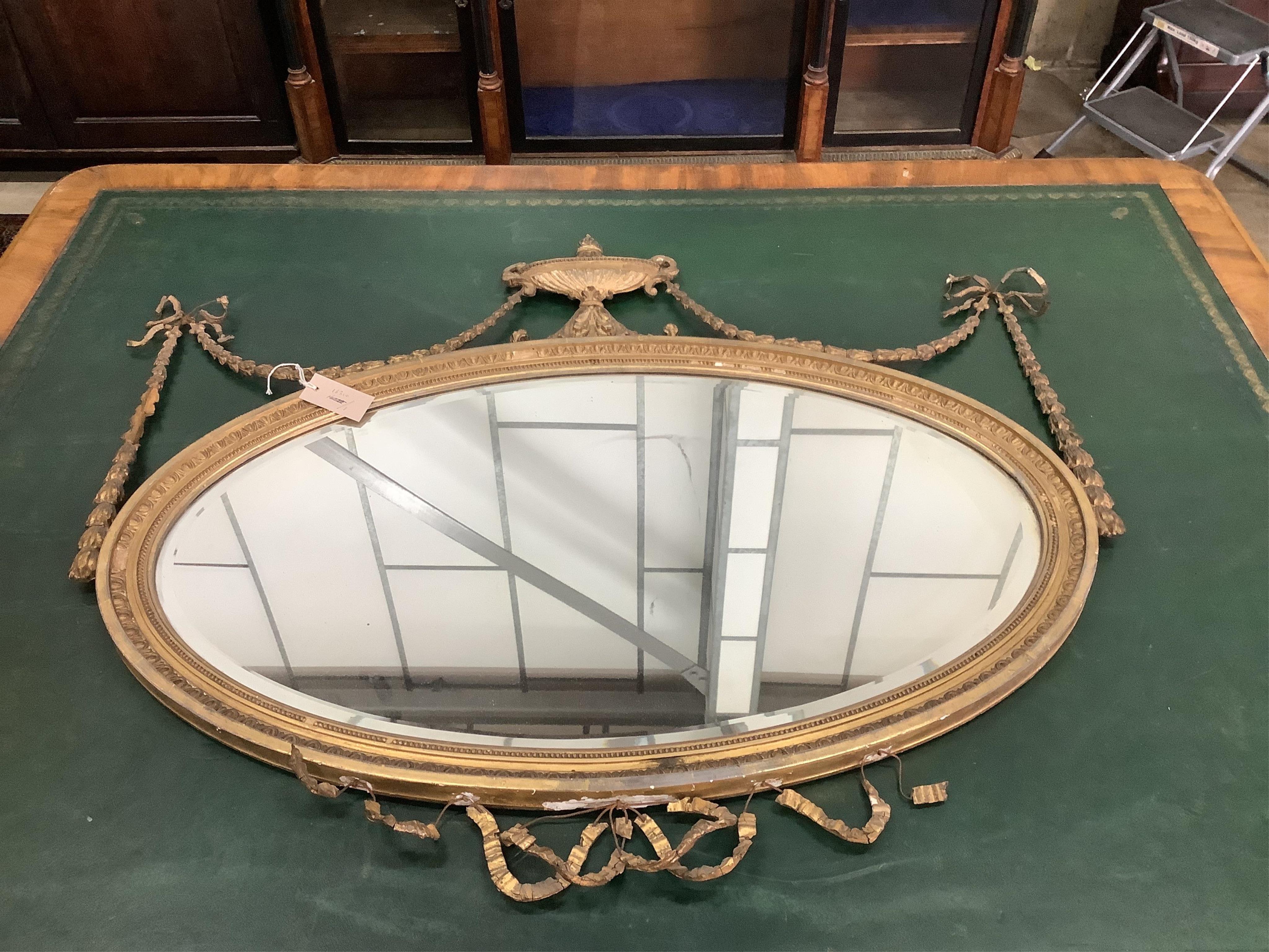 An early 20th century Adam Revival giltwood wall mirror, width 108cm, height 87cm. Condition - numerous losses